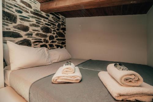 a bed with towels sitting on top of it at Ellafos Traditional Living-Elafonisi Couples Retreat in Elafonisi