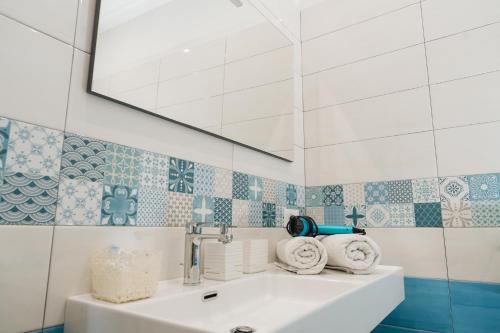 a bathroom with a sink and a mirror at Relais Villa Ettore in Barano d'Ischia