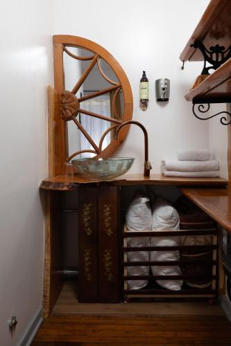 a bathroom vanity with a sink and a mirror at AYCA La Flora Hotel Boutique in Valparaíso