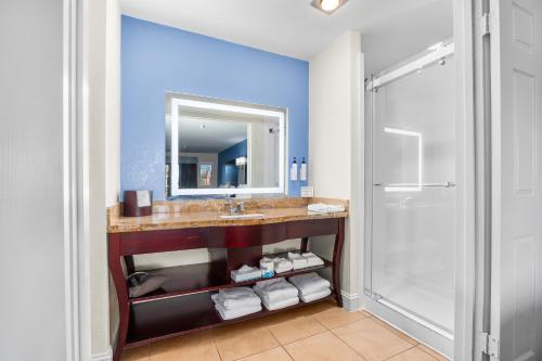 a bathroom with a sink and a mirror and a shower at Hotel Solares in Santa Cruz