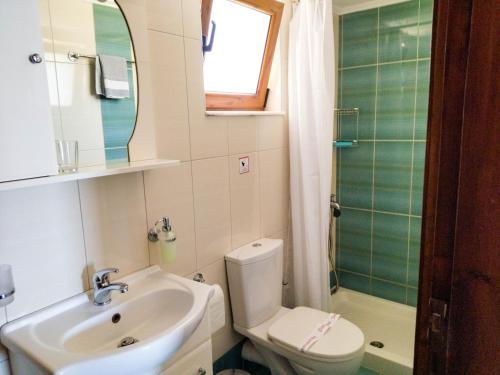 a bathroom with a sink and a toilet and a shower at Ostria Apartments Kalives in Kalyves