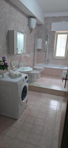 a large bathroom with a washing machine in it at Brezza di Mare in Finale