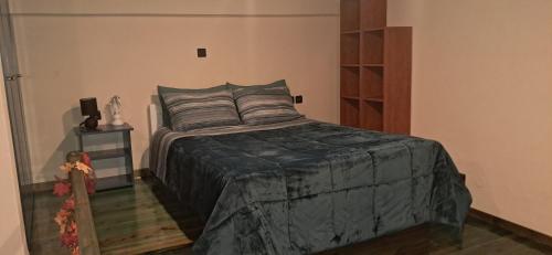 a bedroom with a large bed and a night stand at ABC Studios B in Lamía