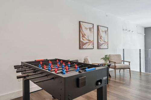 a large black foosball table in a living room at Penthouse Luxe Views No 604 in Dallas