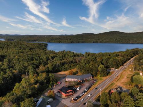 an aerial view of a building next to a lake at Hideaway Inn Mt Sunapee in Newbury