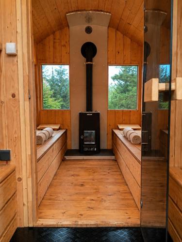 an inside view of a cabin with a wood stove at Domki Bieszczady Siedlisko Harenda in Czarna