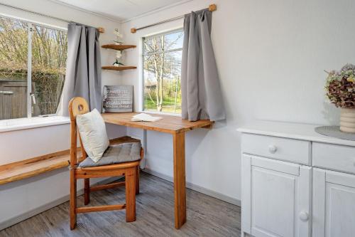 a home office with a wooden desk and a chair at Alte Dorfstraße 29 REETungsring in Behrensdorf