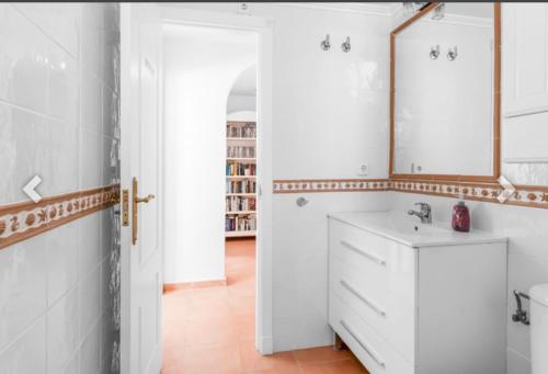 a bathroom with a white sink and a mirror at Casa Lanjaron in San Miguel de Salinas