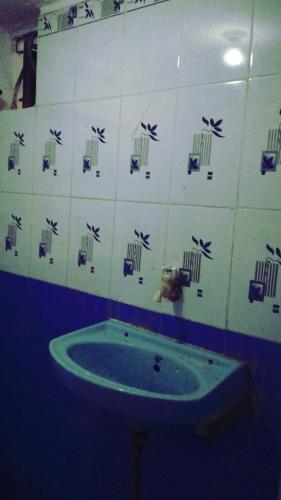 a bathroom with a tub in the corner of a room at Shri chitrakoot homestay in Chitrakoot