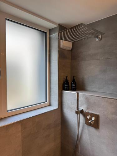 a bathroom with a window and a shelf with bottles at Lichtdurchflutete Suite mit Lichthof in Karlsruhe