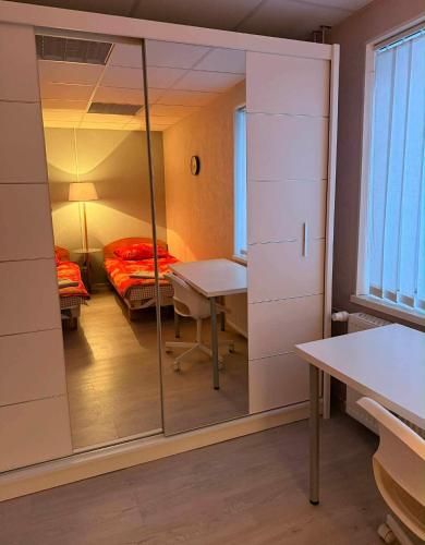 a room with a mirror and a table and a bed at Paide Apartment in Paide