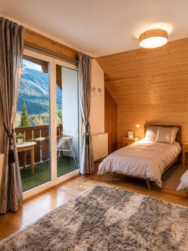 a bedroom with a bed and a large window at Ferienhaus Jenig in Jenig