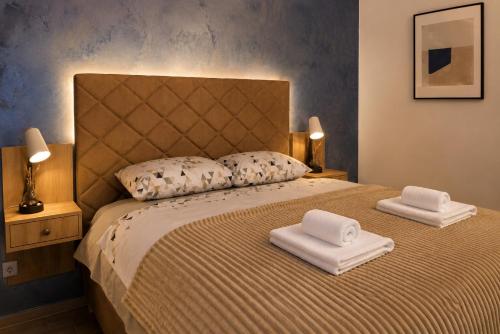 a bedroom with a bed with two towels on it at Blue Skies in Podgorica