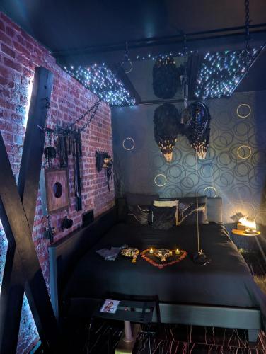 a room with a bed with lights on it at Blacroom de l'Artois in Souchez