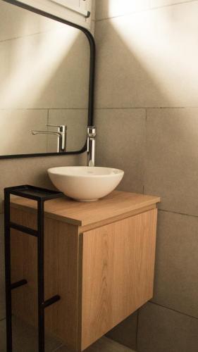 a bathroom with a white sink and a mirror at VAYU LuxuryLofts in Bahía Blanca