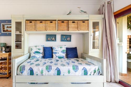 a bedroom with a bed with blue and white sheets at Dunas de vilamoura in Quarteira