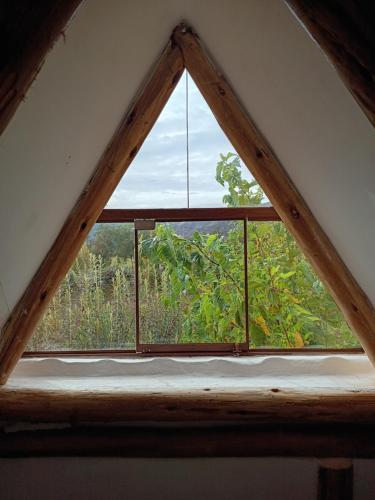 a window in the roof of a house at Mrs Sapo Chalets in Urubamba