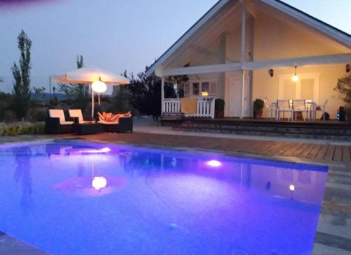 a swimming pool in front of a house at Quinta de Argos in Cehegín