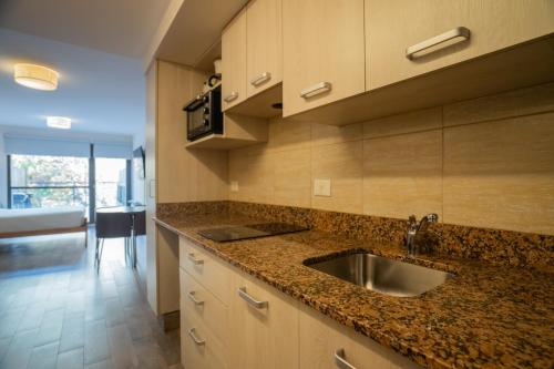 a kitchen with a sink and a counter top at MINI LOFT Departamentos Bariloche in San Carlos de Bariloche