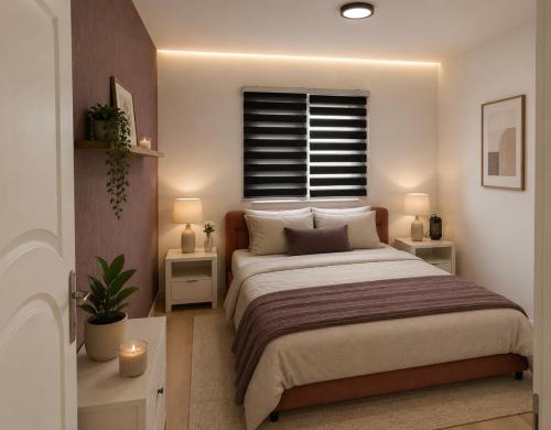 a bedroom with a bed with two night stands and a window at Vila city in Bijeljina
