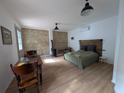 a bedroom with a bed and a desk in a room at Maison Bátori Tarczal in Tarcal