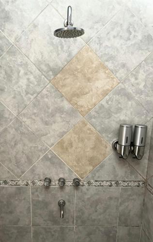 a shower with a tiled floor with a light at challet1 in Yerba Buena