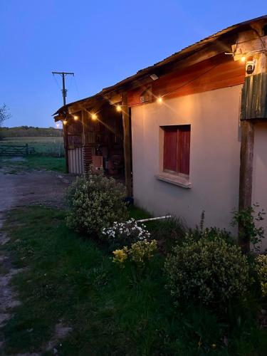 a small house with lights on the side of it at Cranford Oak Farm Campsite in Barnstaple