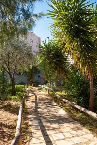 a path with palm trees and a building at Iliothea in Nafplio