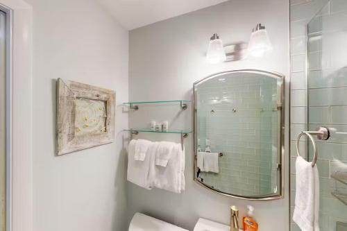 a bathroom with a shower and a sink and a mirror at Andros Suite in Key West
