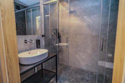 a bathroom with a sink and a shower at Lofft Hotel in Ciechanów