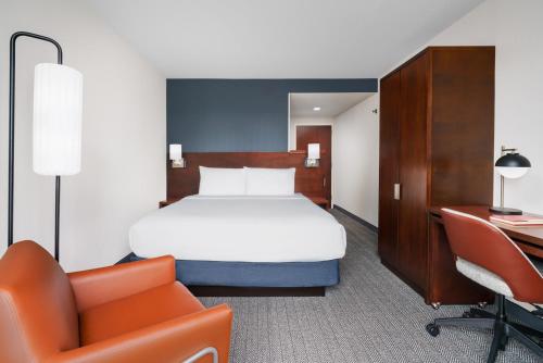 a hotel room with a bed and a desk at Courtyard by Marriott New York Manhattan Upper East Side in New York