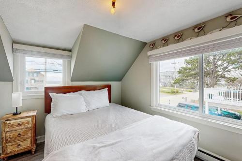a bedroom with a bed and a large window at Wishing Wells in Wells