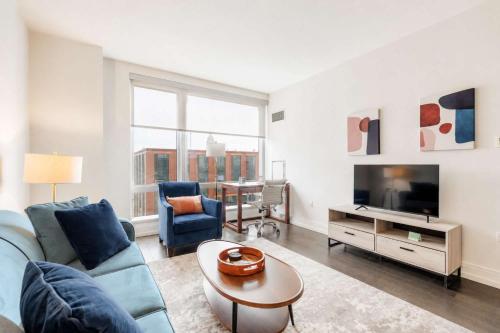 a living room with a couch and a tv at Luxury Apt with Gym & Pool in New York