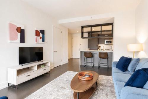 a living room with a blue couch and a table at Luxury Apt with Gym & Pool in New York