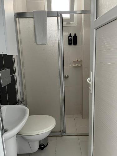 a bathroom with a shower and a toilet and a sink at Caretta Vita Bella in Silifke