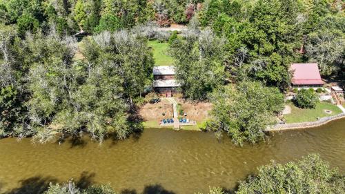 an aerial view of a house in the middle of a lake at A Rivers Edge in Mineral Bluff