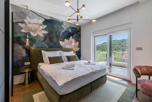 a bedroom with a large flower painting on the wall at Countryside family villa with pool Zmina in Donji Muć