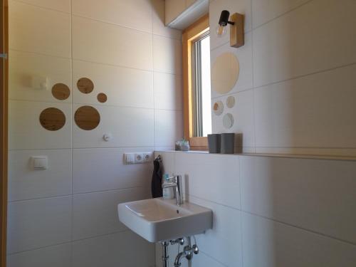 a white bathroom with a sink and a mirror at Ferienhaus Traumblick-Neustadt in Neustadt an der Weinstraße