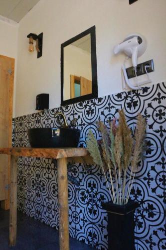 a bathroom with a sink and a mirror on a wall at Ruina Glamping in Mezgit
