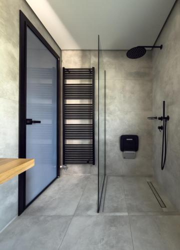 a shower with a glass door in a bathroom at Astraea Villa in Karistos