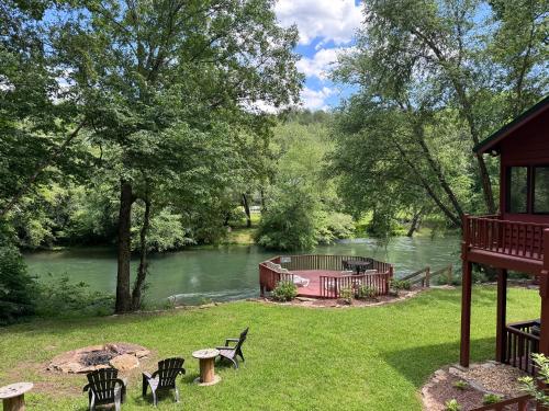 a view of a river with a gazebo and a bridge at Bigfoots River Retreat in Mineral Bluff