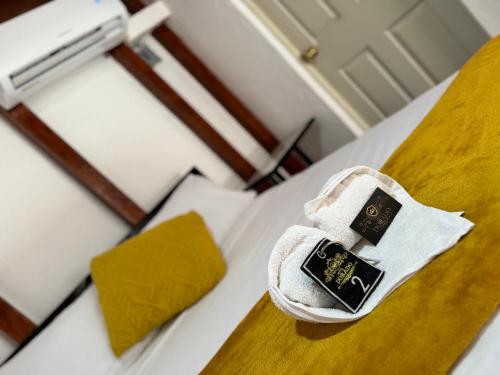 a pair of shoes sitting on top of a bed at Hotel DORADO in Tapachula
