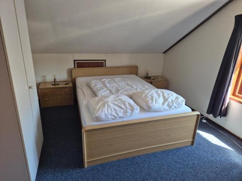 a bedroom with a bed with two pillows on it at Molenzicht in Elspeet