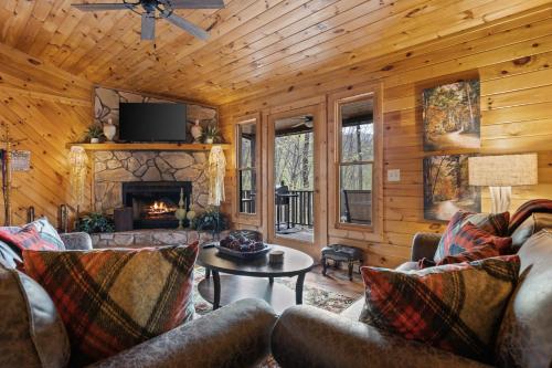 a living room with a couch and a fireplace at Hearts Hideaway in Morganton