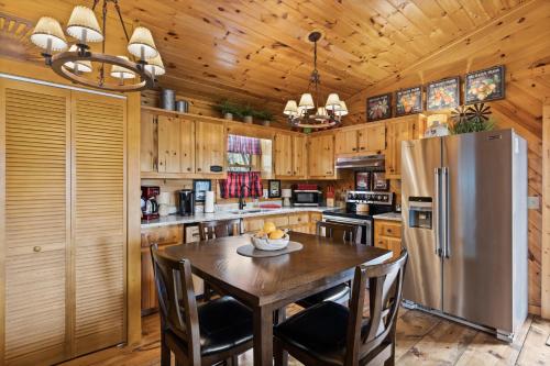 a kitchen with a table and a refrigerator at Hearts Hideaway in Morganton