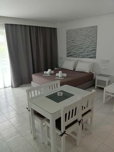 a living room with a bed and a table and chairs at Casa al'tati studio 27 in Ialysos