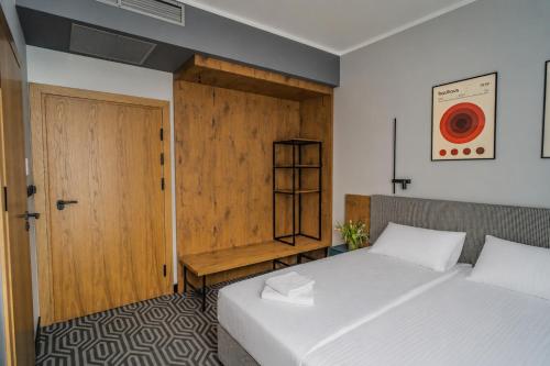 a bedroom with two beds and a wooden door at Lofft Hotel in Ciechanów