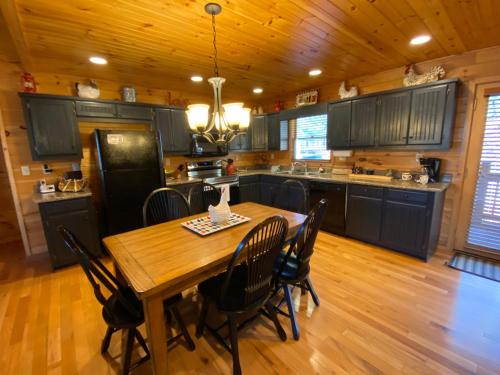 a large kitchen with a wooden table and chairs at Lallybroch in Morganton