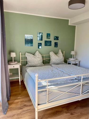 a bed in a room with two tables and two lamps at mf Guesthouse in Sukow
