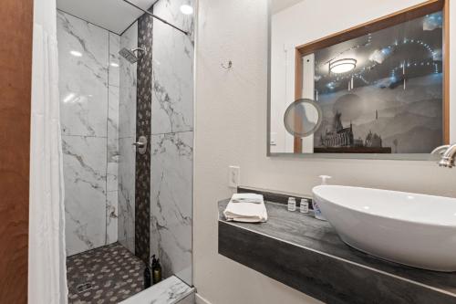 a bathroom with a sink and a glass shower at Library INN - Boutique Rooms - Free Breakfast - Hot Tub in Lava Hot Springs